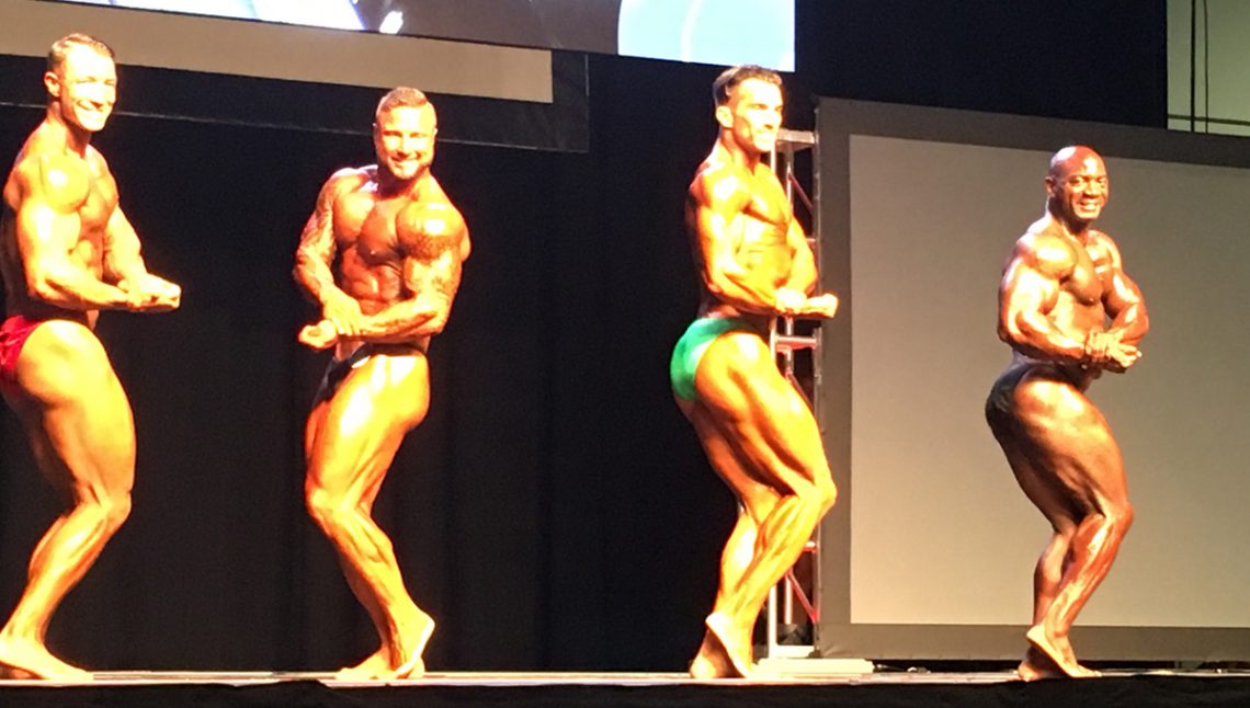 Seena Khonsari on Stage - Sides- Personal Trainer & 1st Place Heavyweight - Gold Medal Bodybuilding & Coach