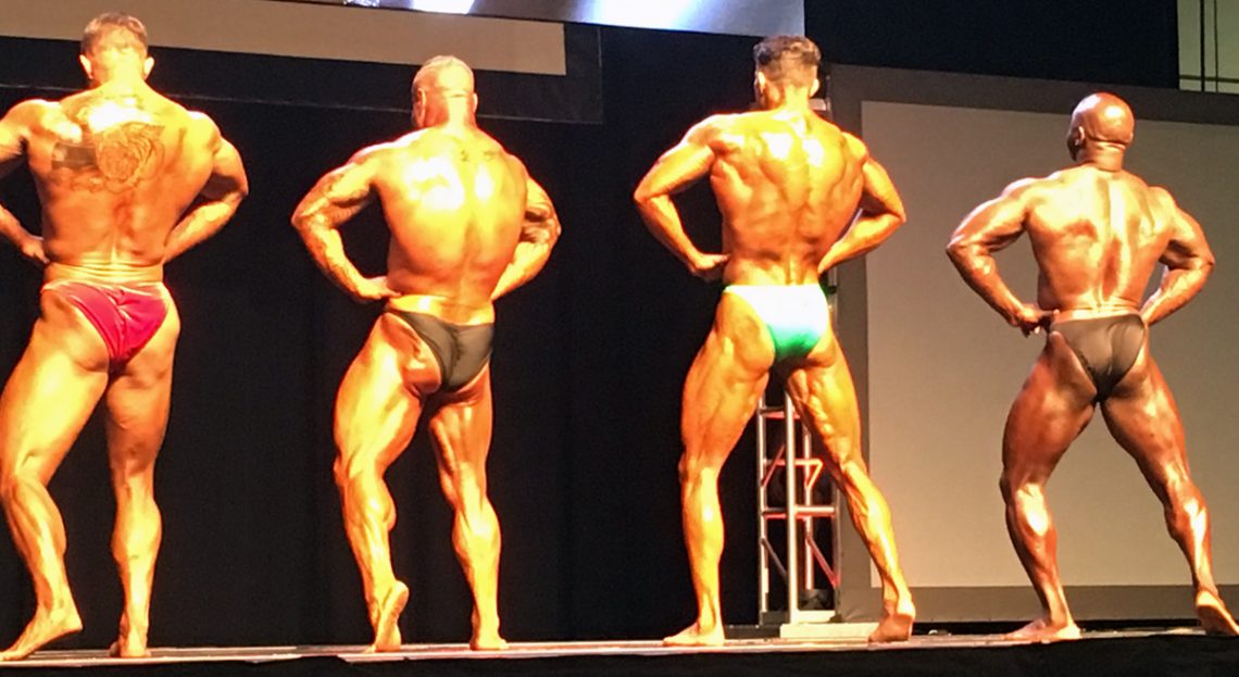 Seena Khonsari on Stage - Backs - Personal Trainer & 1st Place Heavyweight - Gold Medal Bodybuilding & Coach